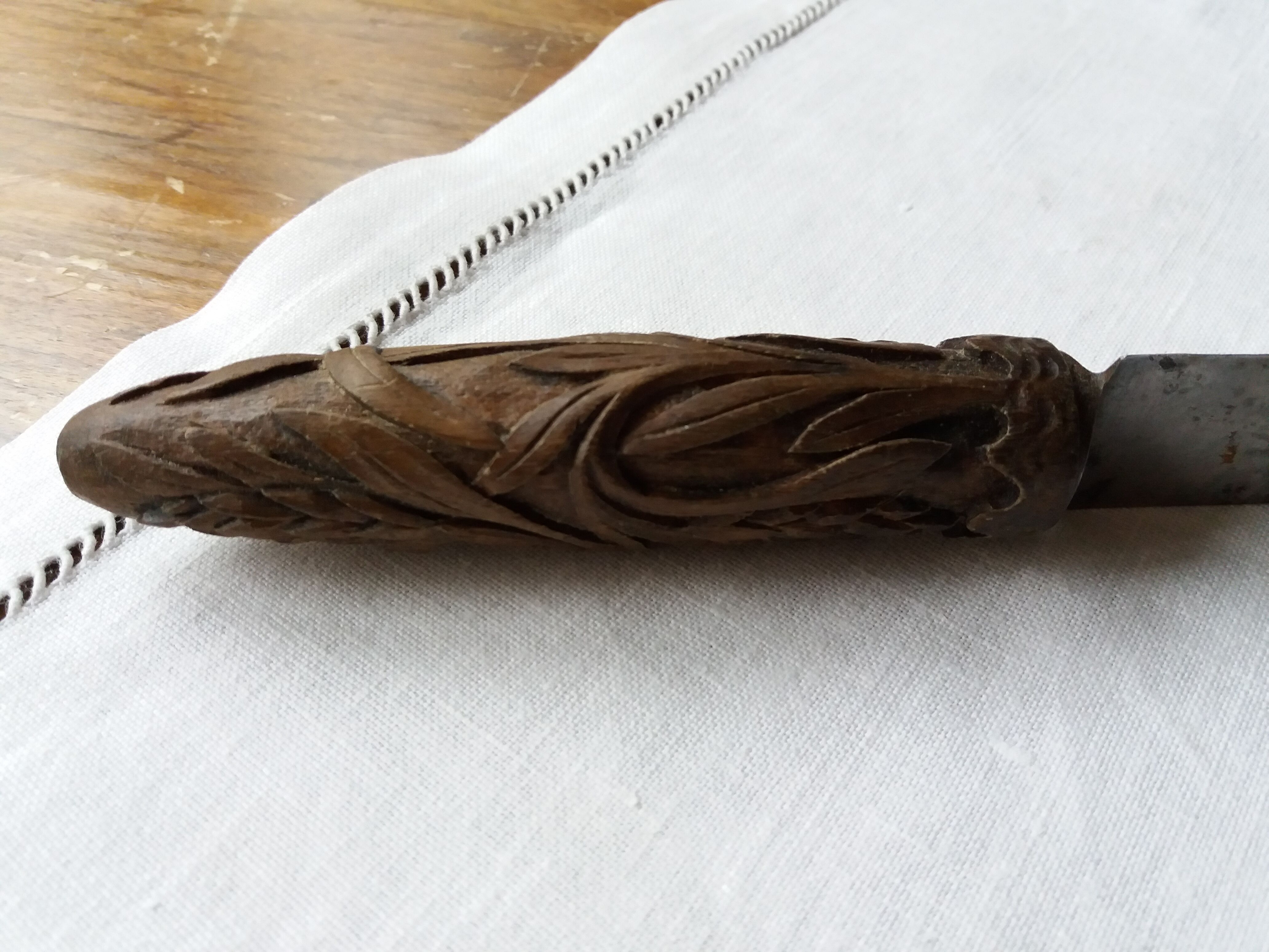 Old bread knife with a carved wooden handle