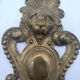 Brass lion head. Furniture decoration, leftover knocker or large nail cover?