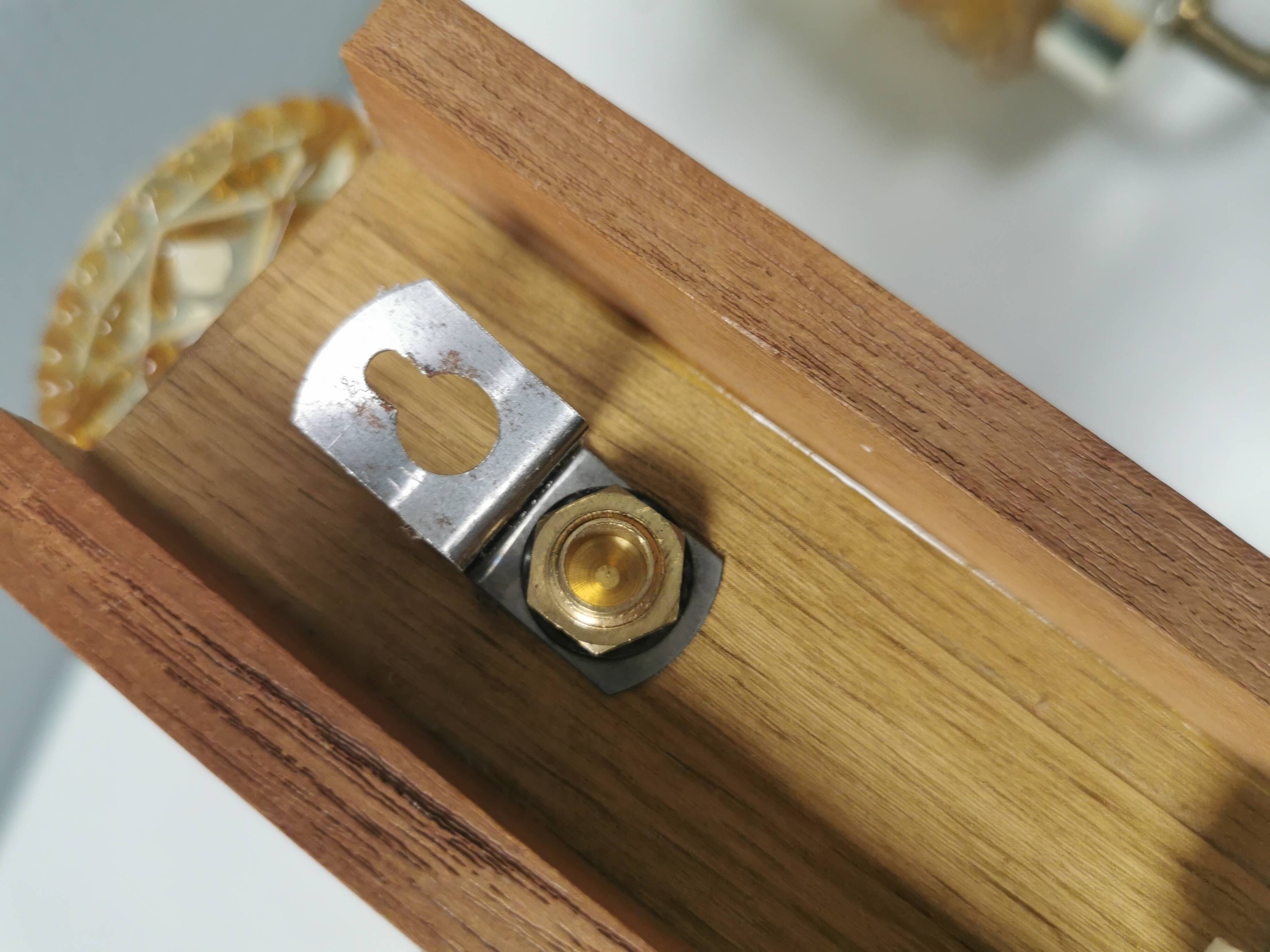 A set of wall lamps in teak wood, with amber colored glass