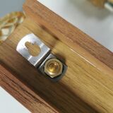 A set of wall lamps in teak wood, with amber colored glass