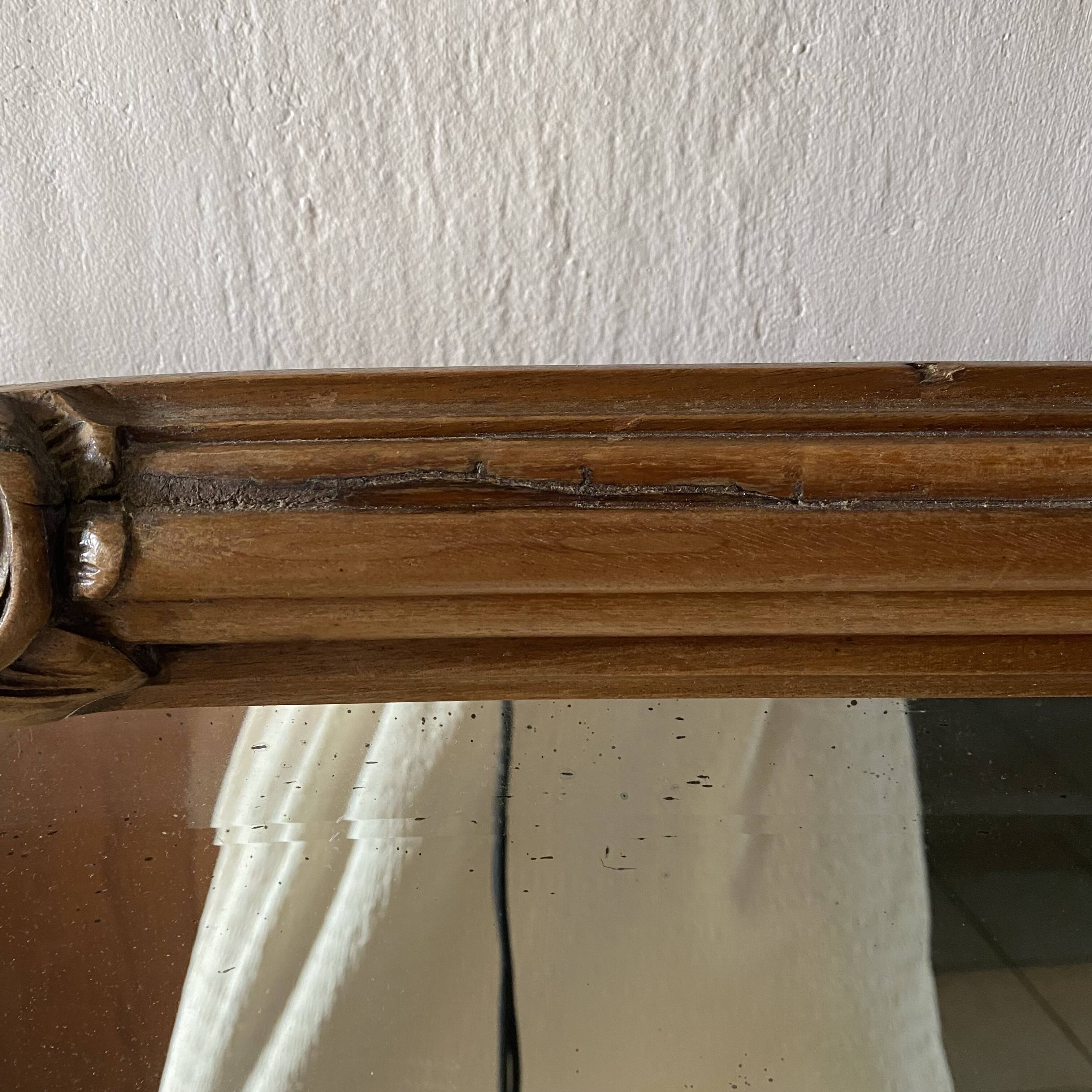 Beveled art deco mirror, carved wood