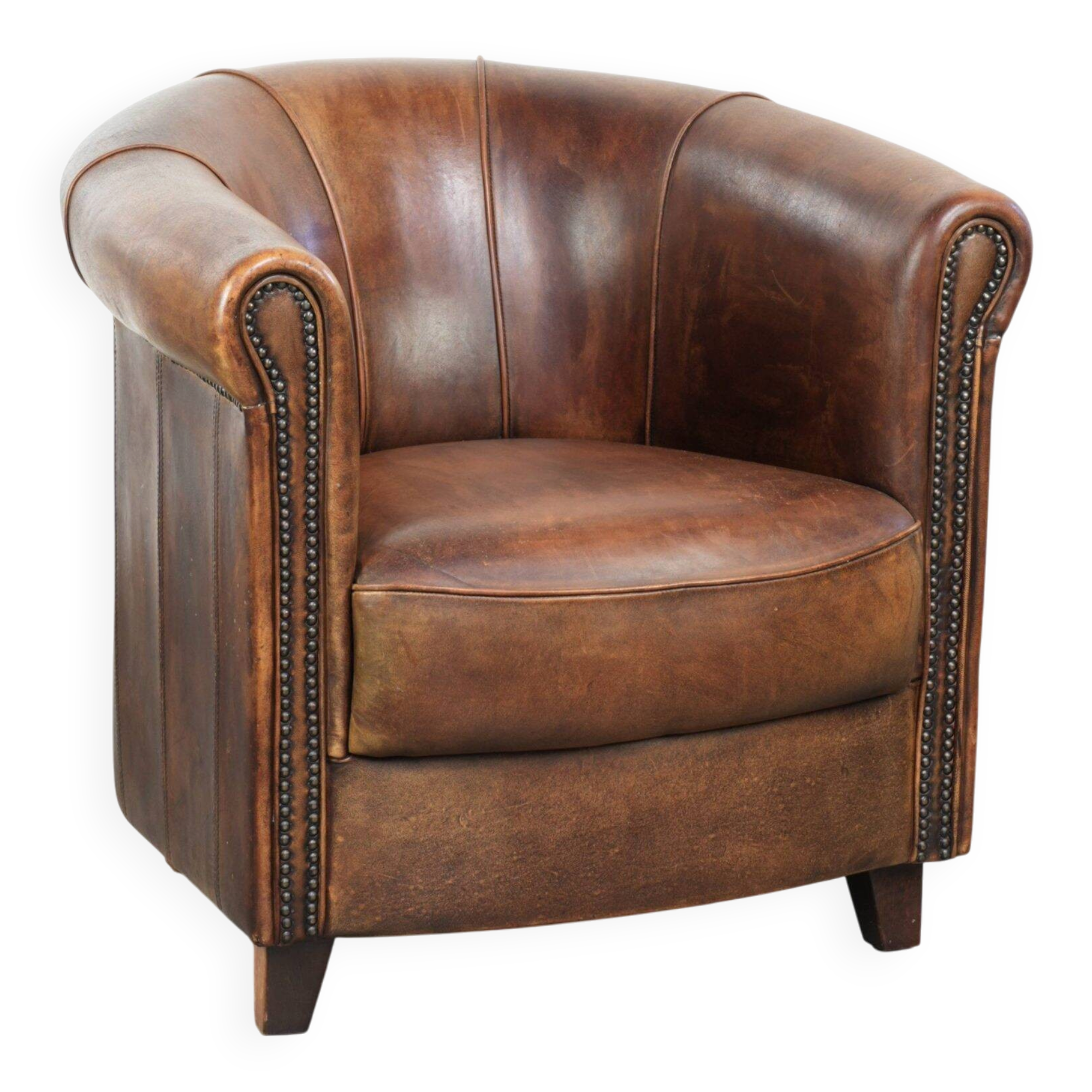 Sheepskin clubarmchair with beautiful patina finished with decorative nails