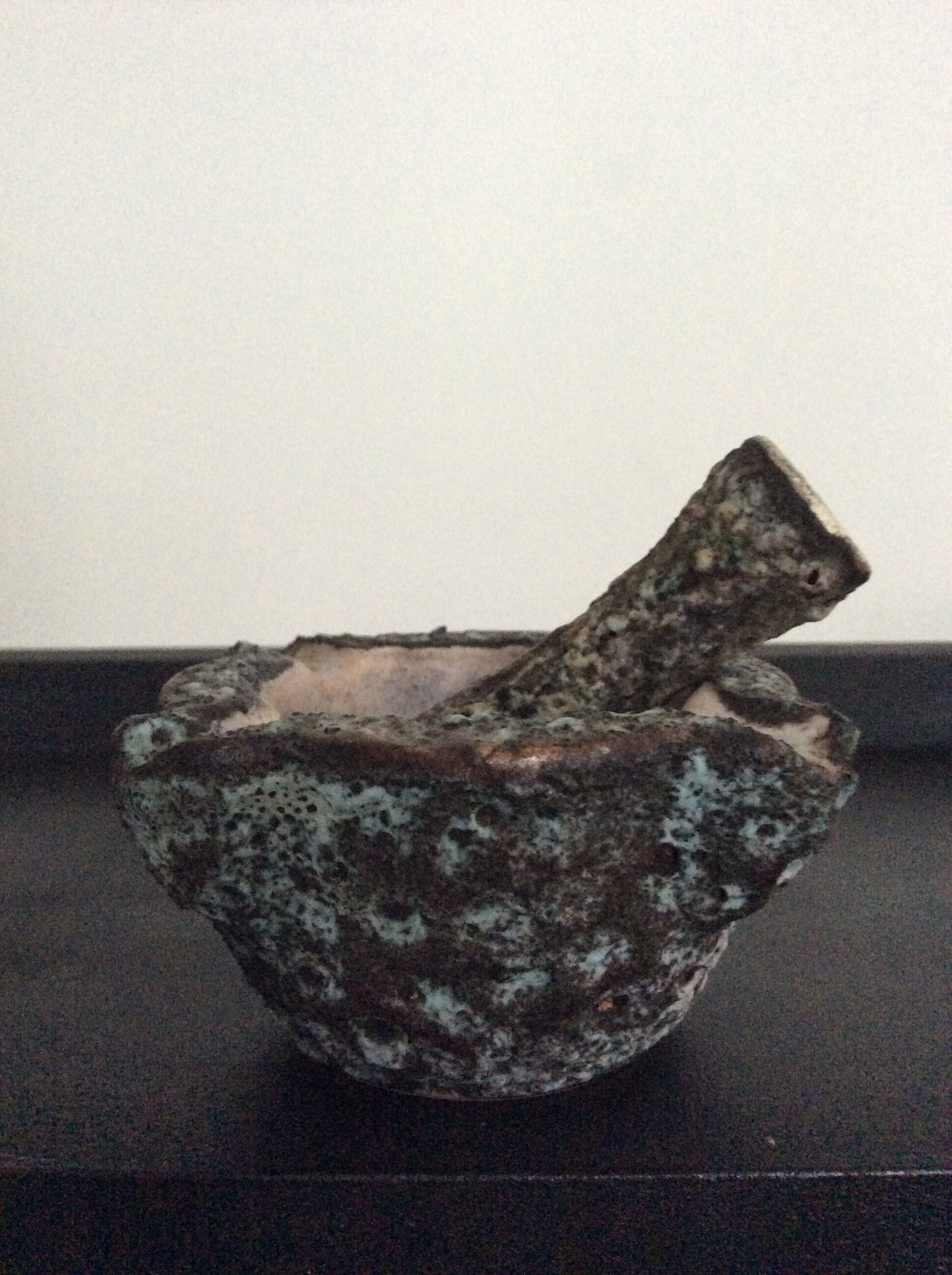 Old mortar and its ceramic pestle Fat Lava