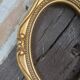 Stylized oval gold frame