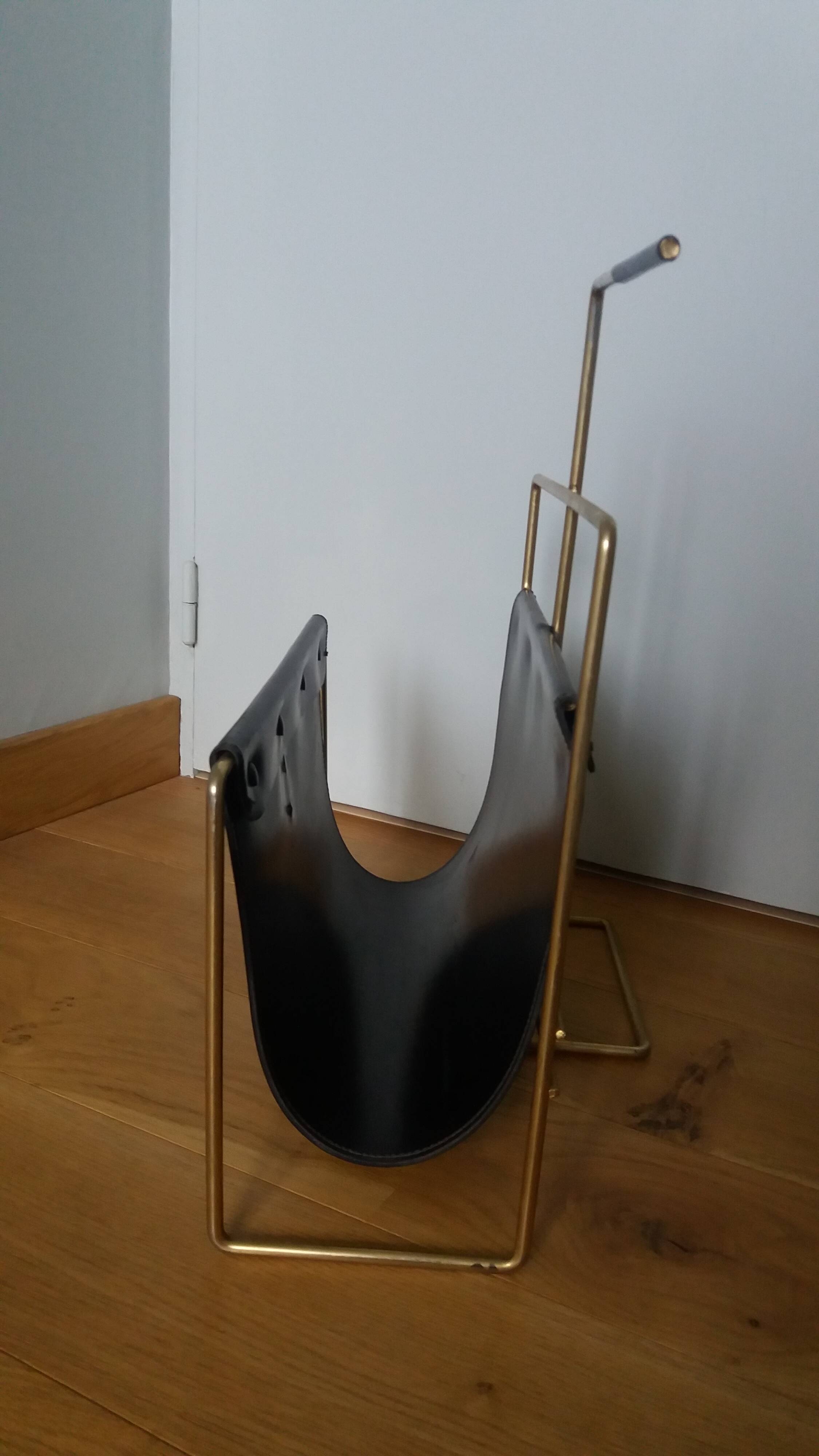 Modernist magazine rack in the style of Jacques Adnet