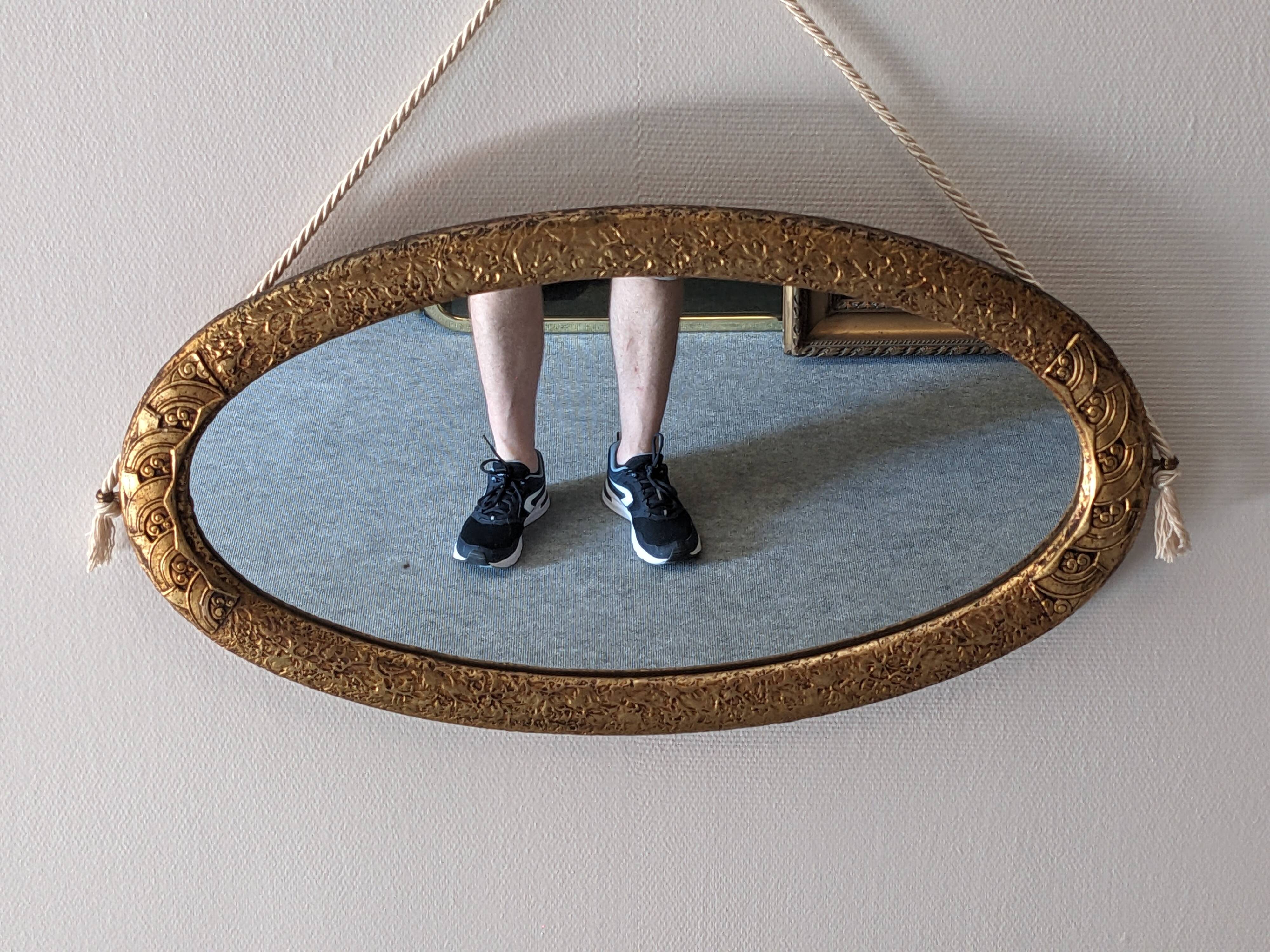 Art Deco oval mirror in gilded wood, France circa 1920