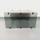 Table basse vintage en verre fumé, métal noir et fonte d’aluminium
