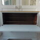 Vintage shoe cabinet green of gray, wooden top.
