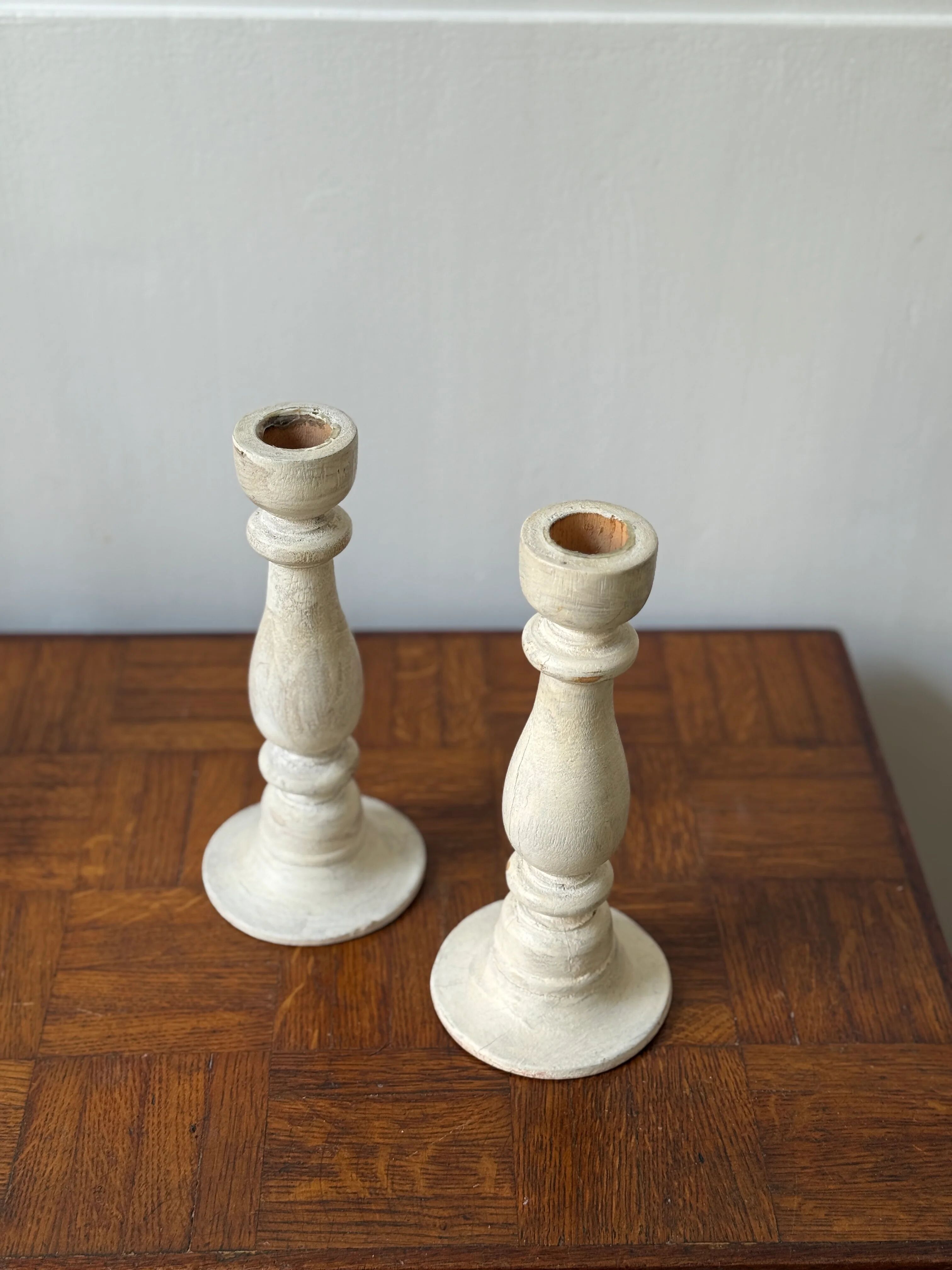 Pair of white wooden candlesticks