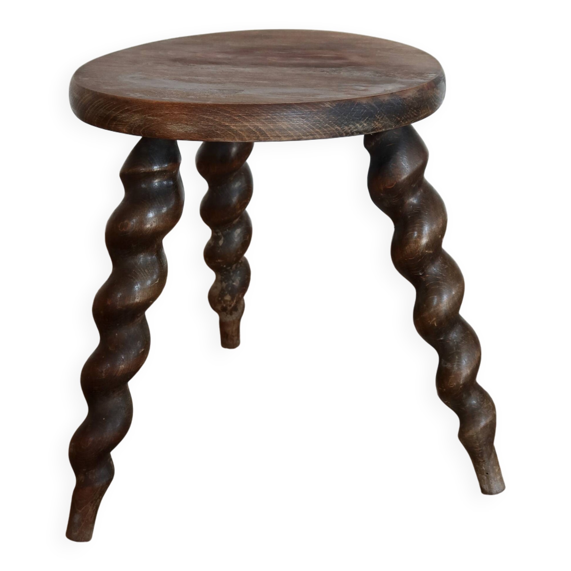 Antique tripod stool made of turned wood.