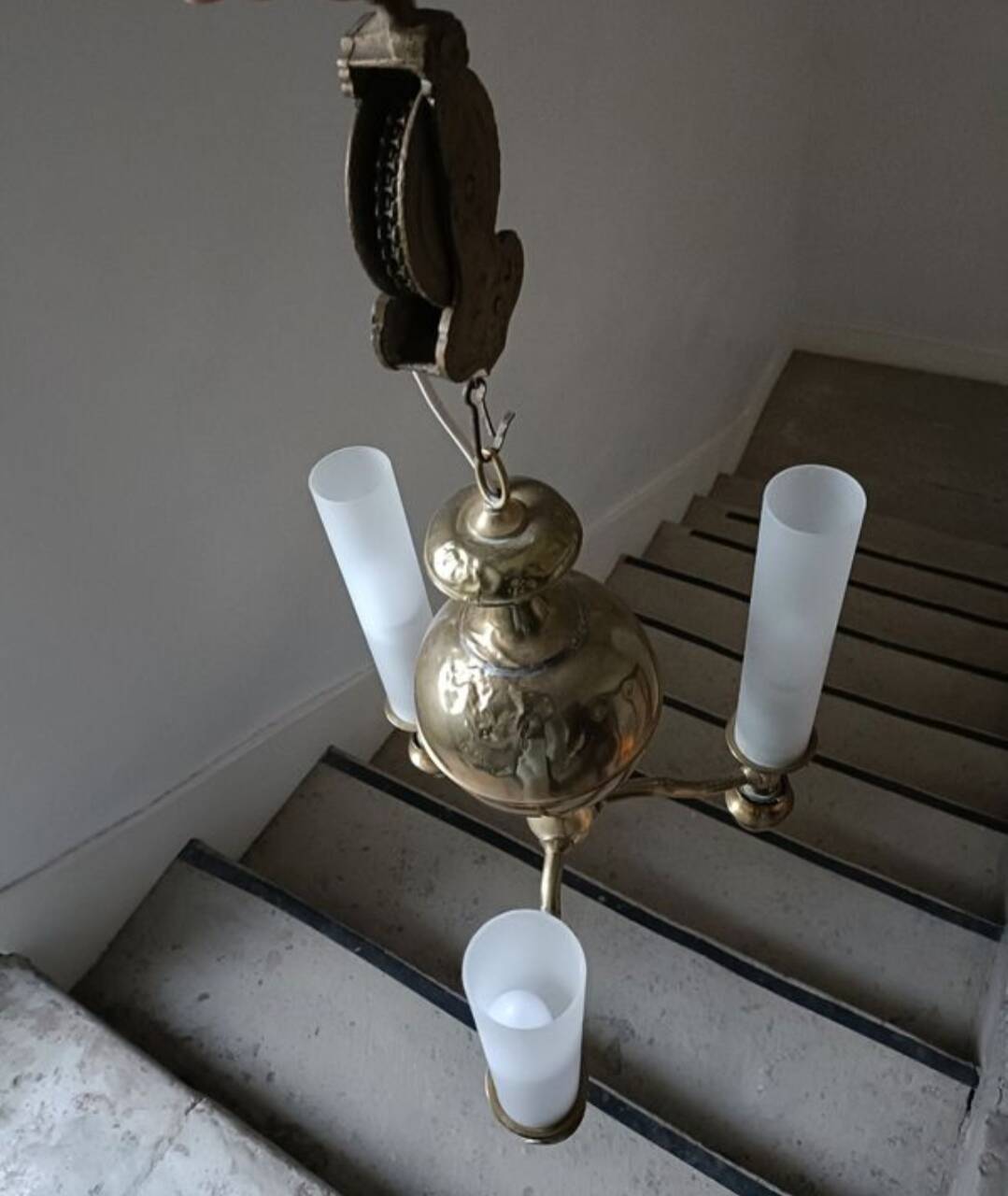 Brass chandelier with three flames.