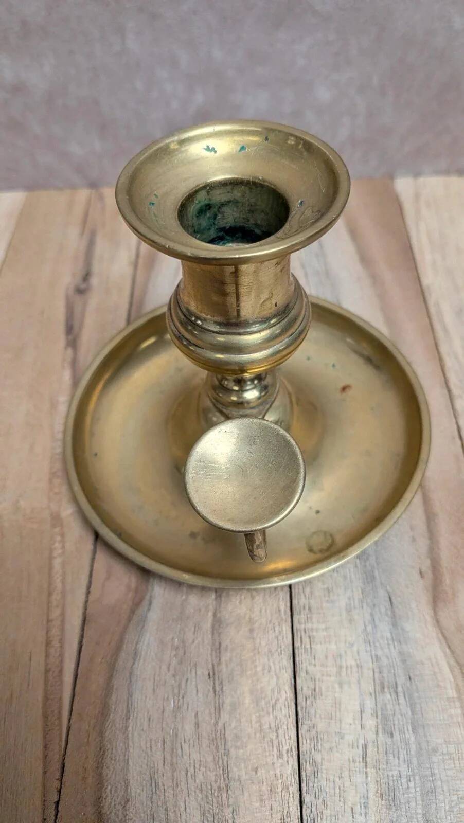 Antique brass candlestick with pusher