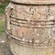 Large Cretan jar in terracotta with three handles on a stone base.