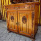 Antique carved wooden sideboard with several sculptures.