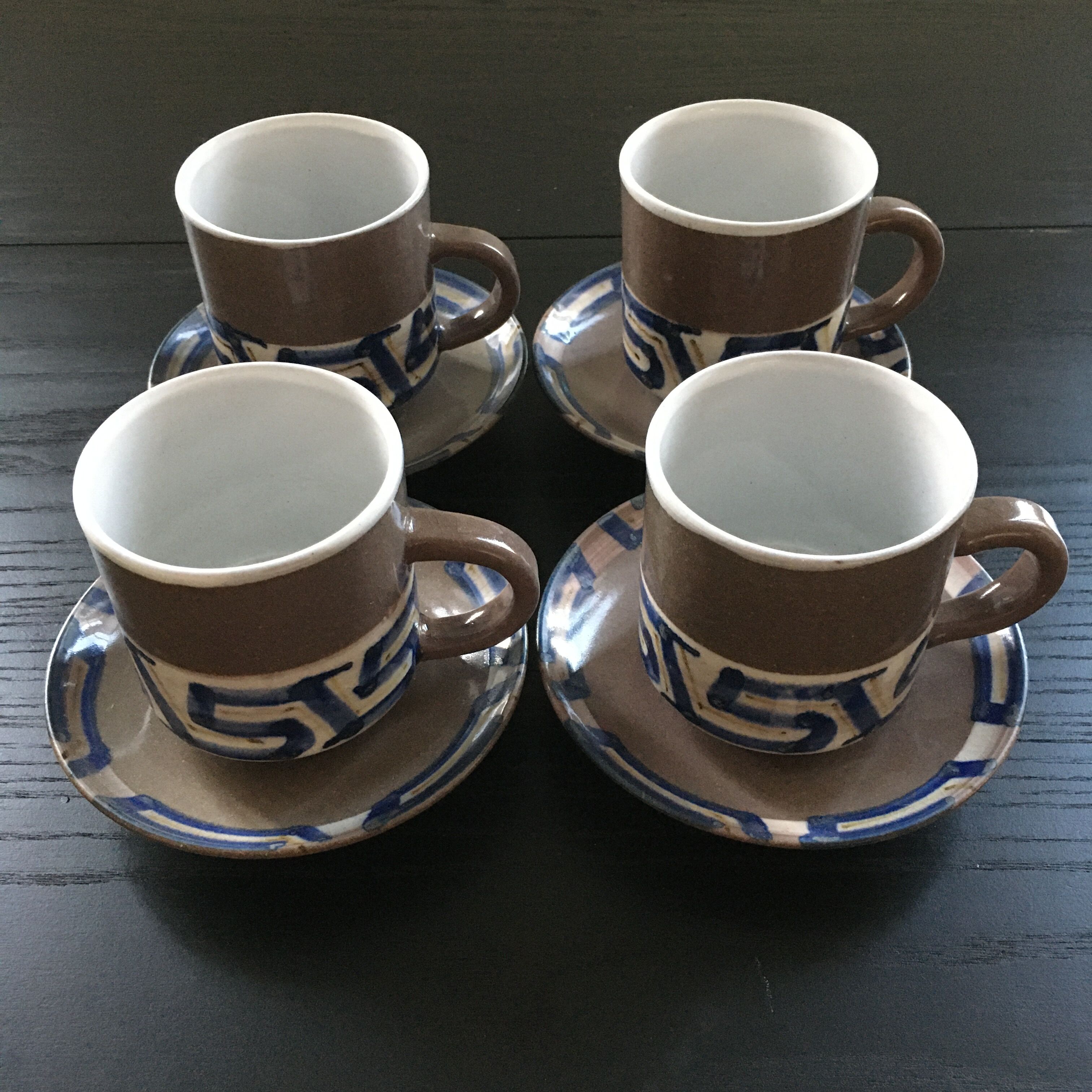 Set of 4 brown stoneware mugs and saucers with blue decor