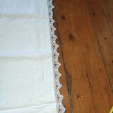 Ancient monogrammed pillowcase adorned with cotton lace
