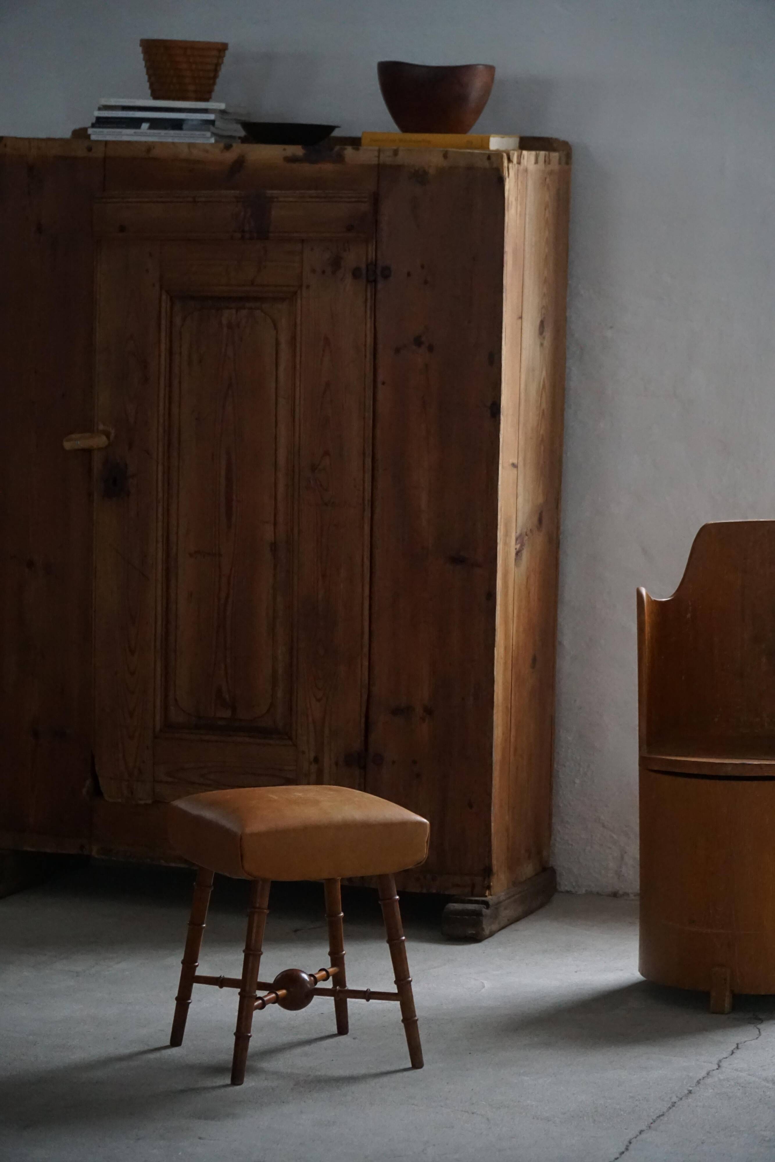 Turned wooden stool with leather seat, mid-20th century, Danish modern.