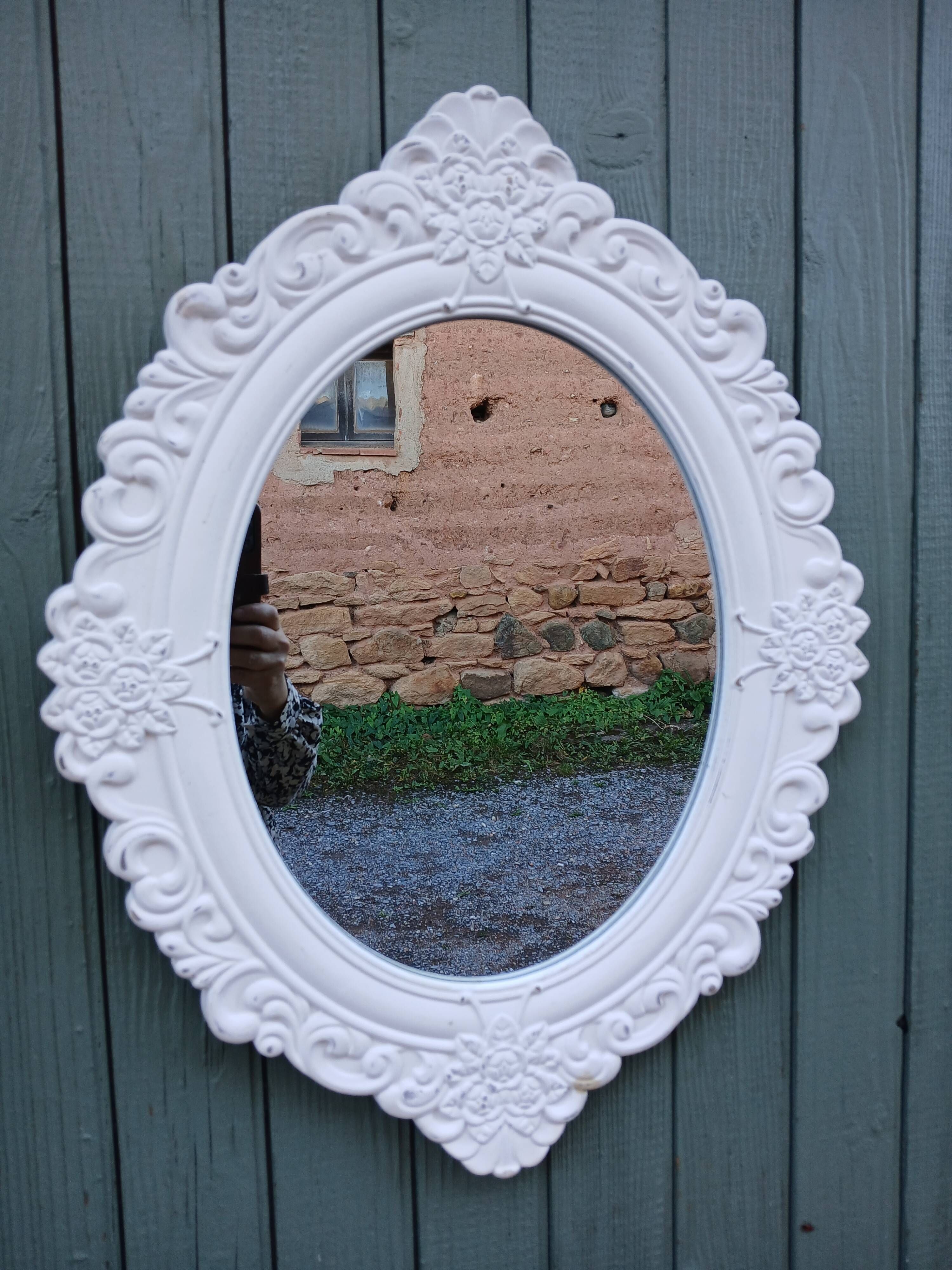 Oval mirror with white frame