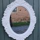 Oval mirror with white frame