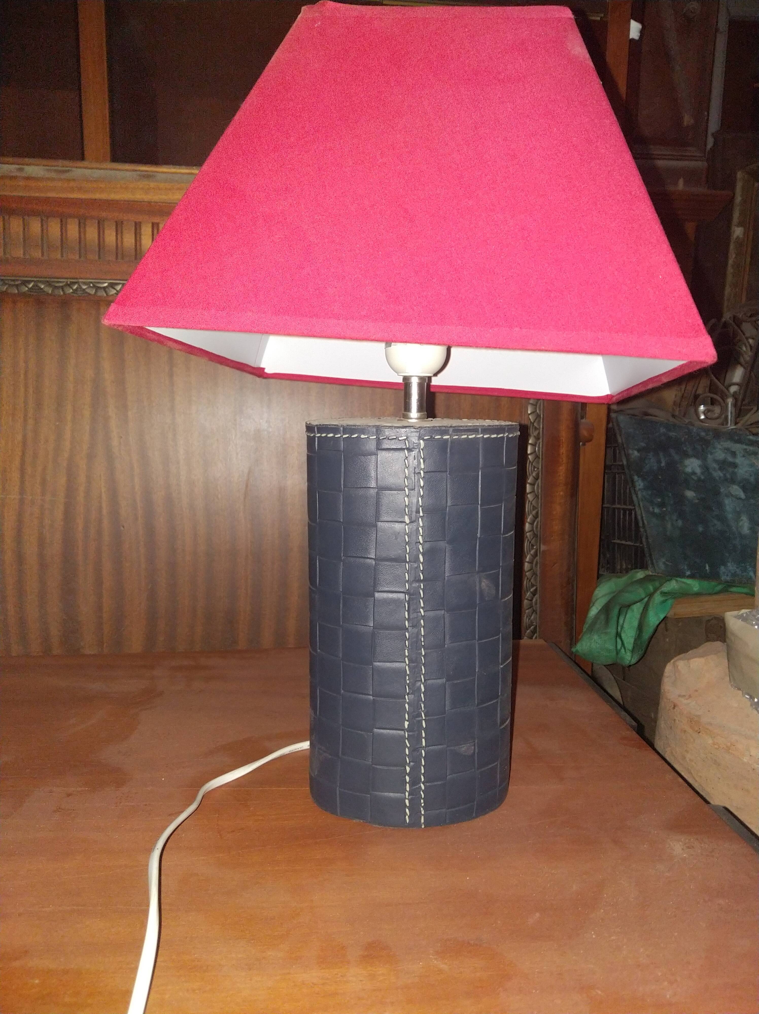 Ovoid lamp sheathed in braided blue leather and saddle stitching