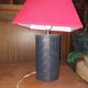 Ovoid lamp sheathed in braided blue leather and saddle stitching