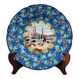 Longwy plate with polychrome enamels, decorated with the "City of Iron" motif.