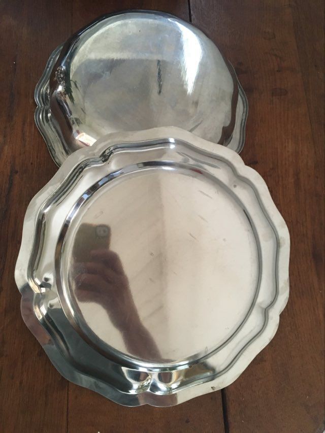 Two matching round dishes in stainless steel