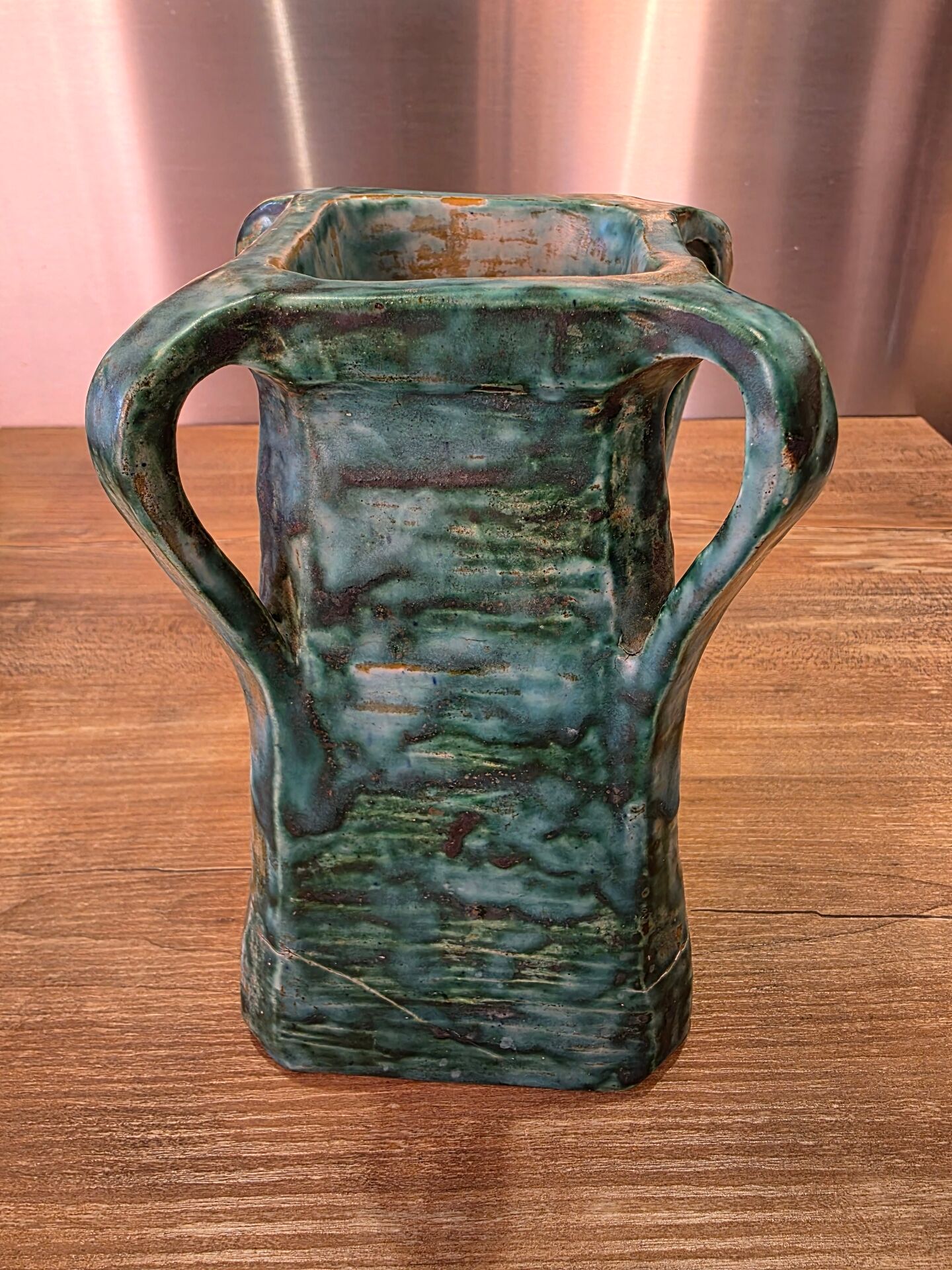 Vintage brutalist ceramic vase with 4 green handles.