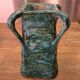 Vintage brutalist ceramic vase with 4 green handles.