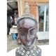 African statue of a woman, made of wood, brass, beads, and seashells.