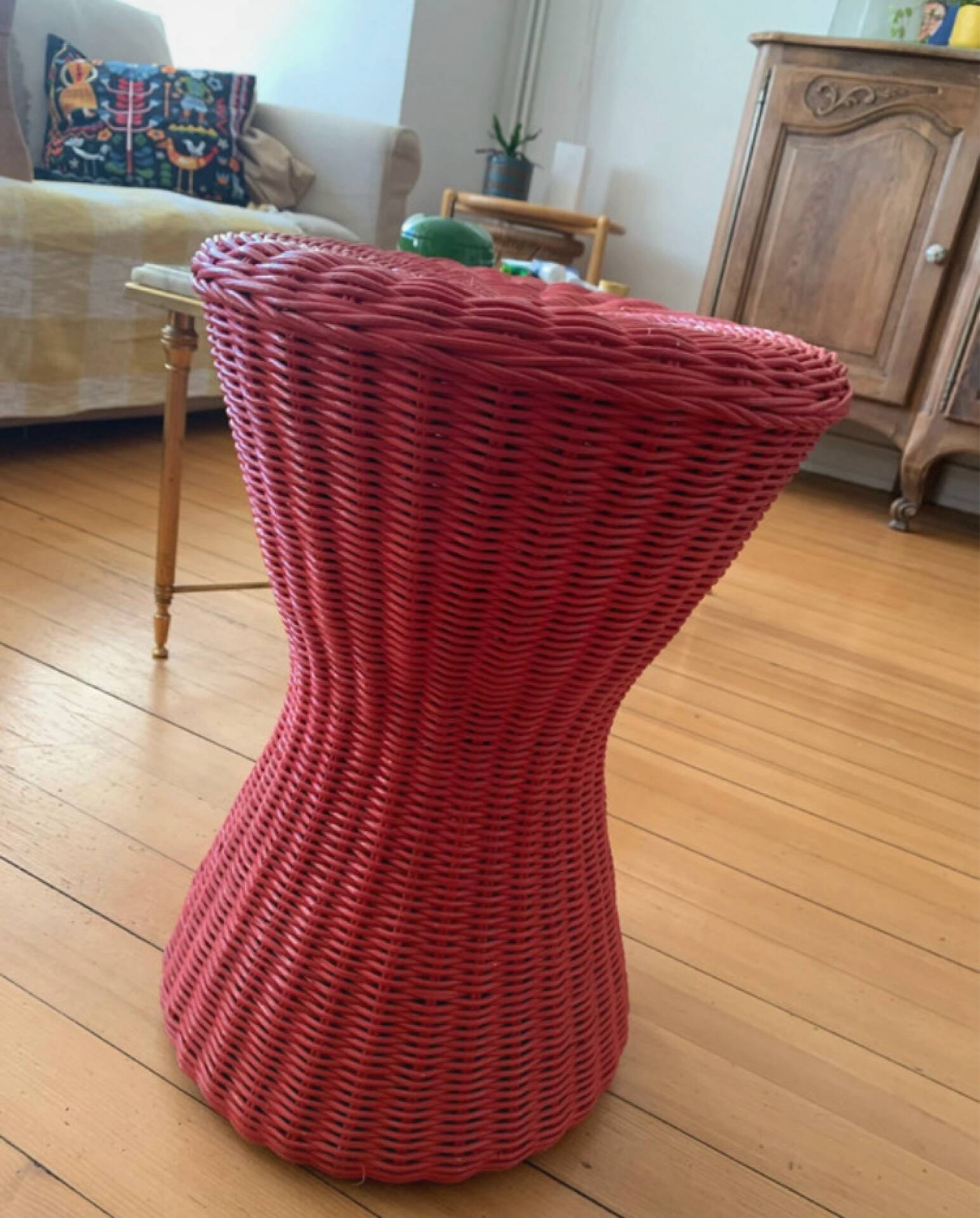 Vintage hourglass stool in red wicker or woven rattan.