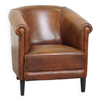 Neat, elegantly finished, cozy sheepskin club armchair with a fixed seat cushion