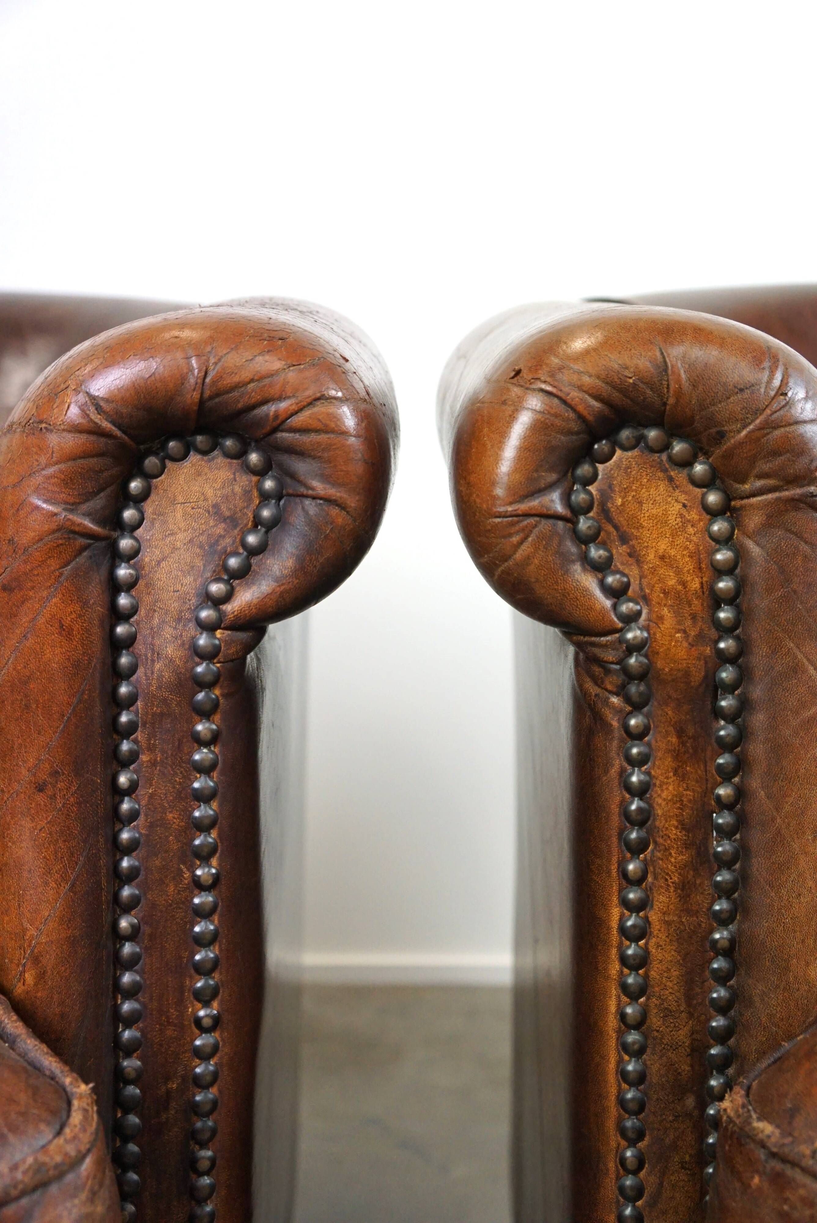 Set of two rugged sheep let of two rugged sheep leather club armchairs with a nice distressed look