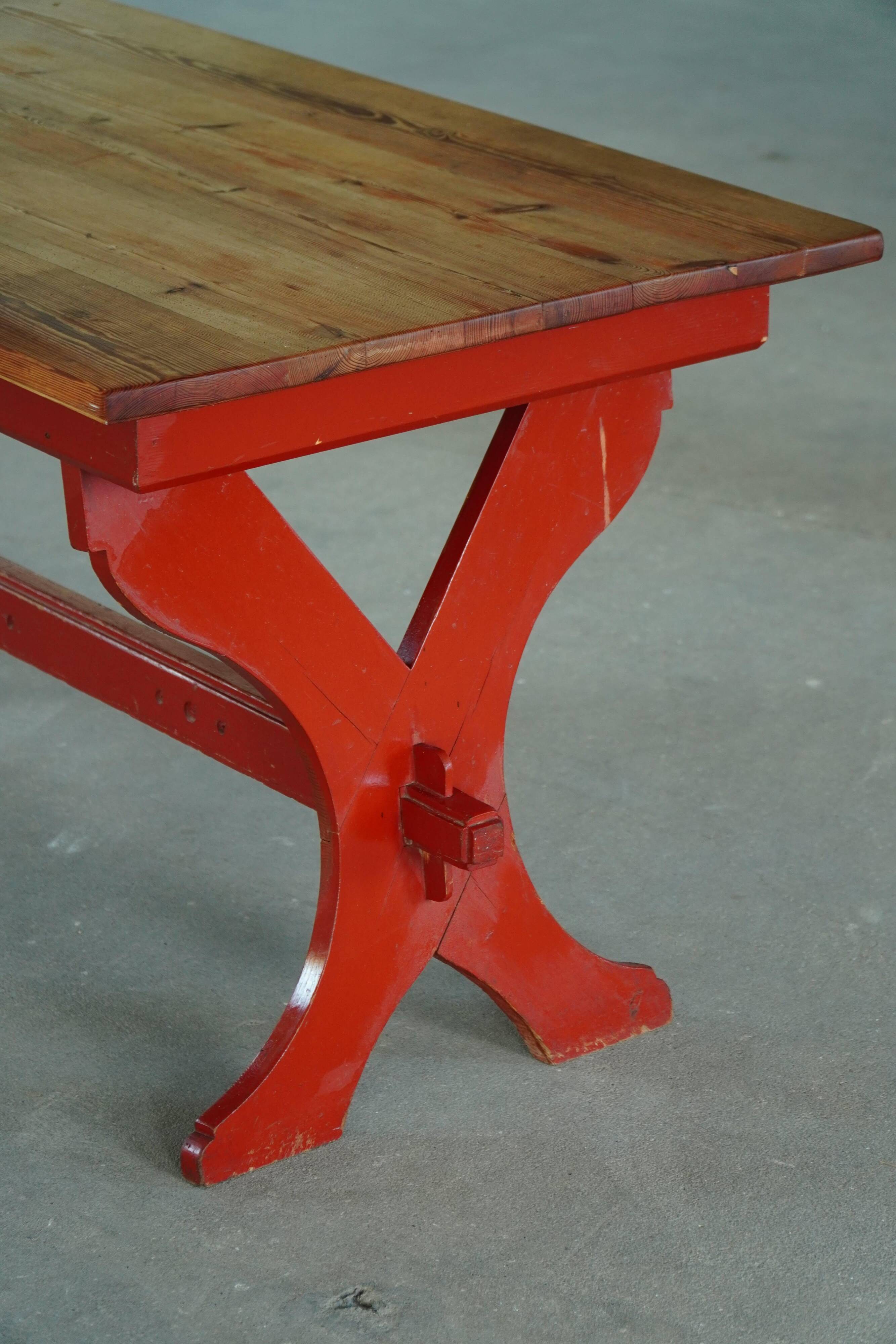 Rustic farmhouse dining table in painted red pine, Sweden, 1920s.