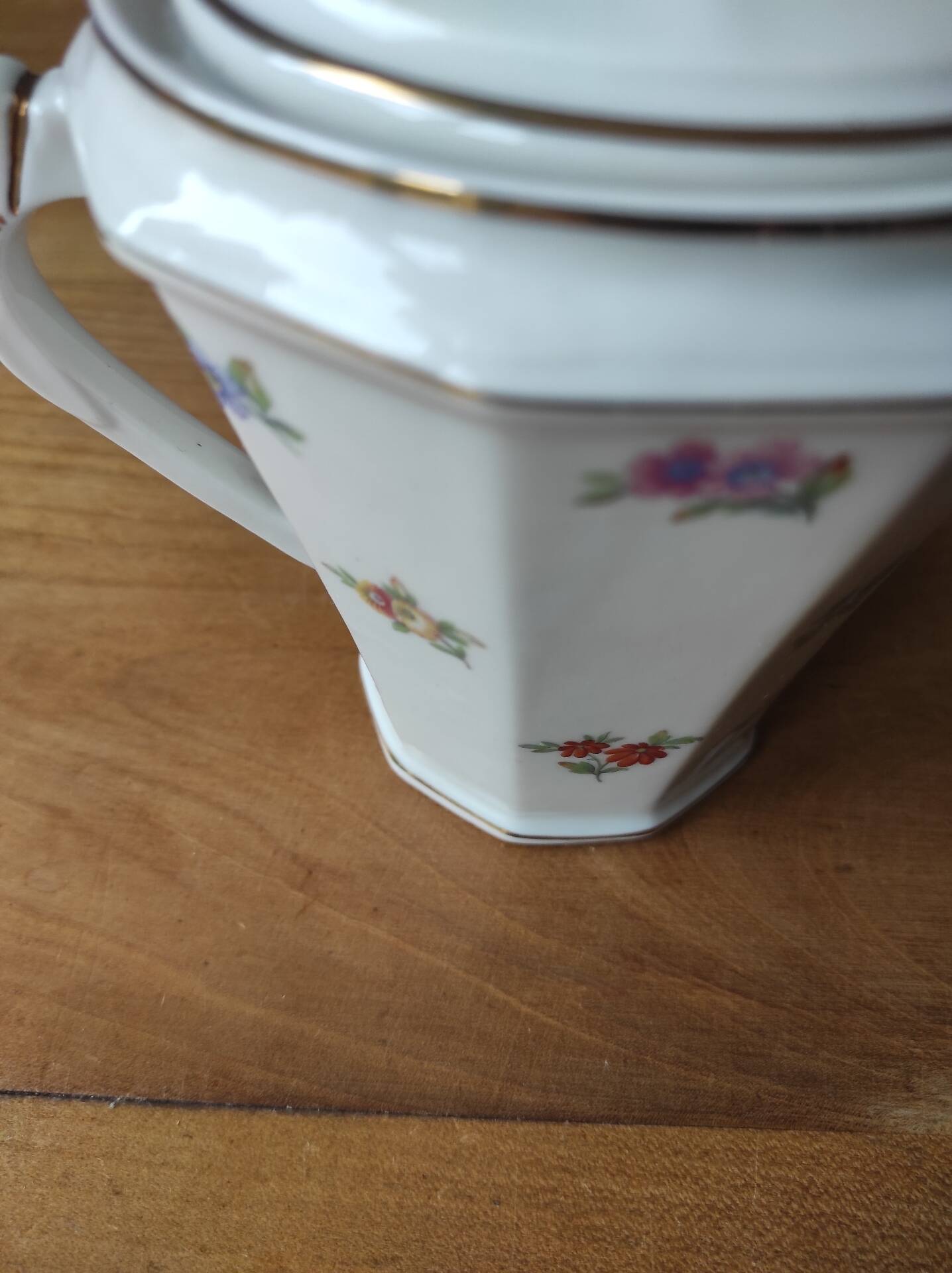 Antique porcelain sugar bowl with a decagonal base.