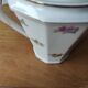 Antique porcelain sugar bowl with a decagonal base.