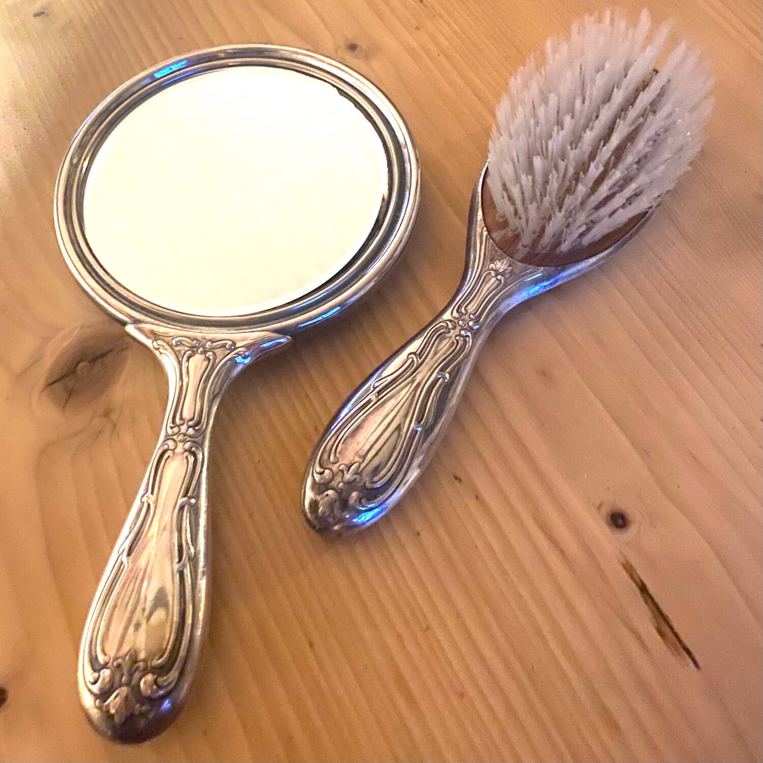 Silver metal hand mirror and laundry brush
