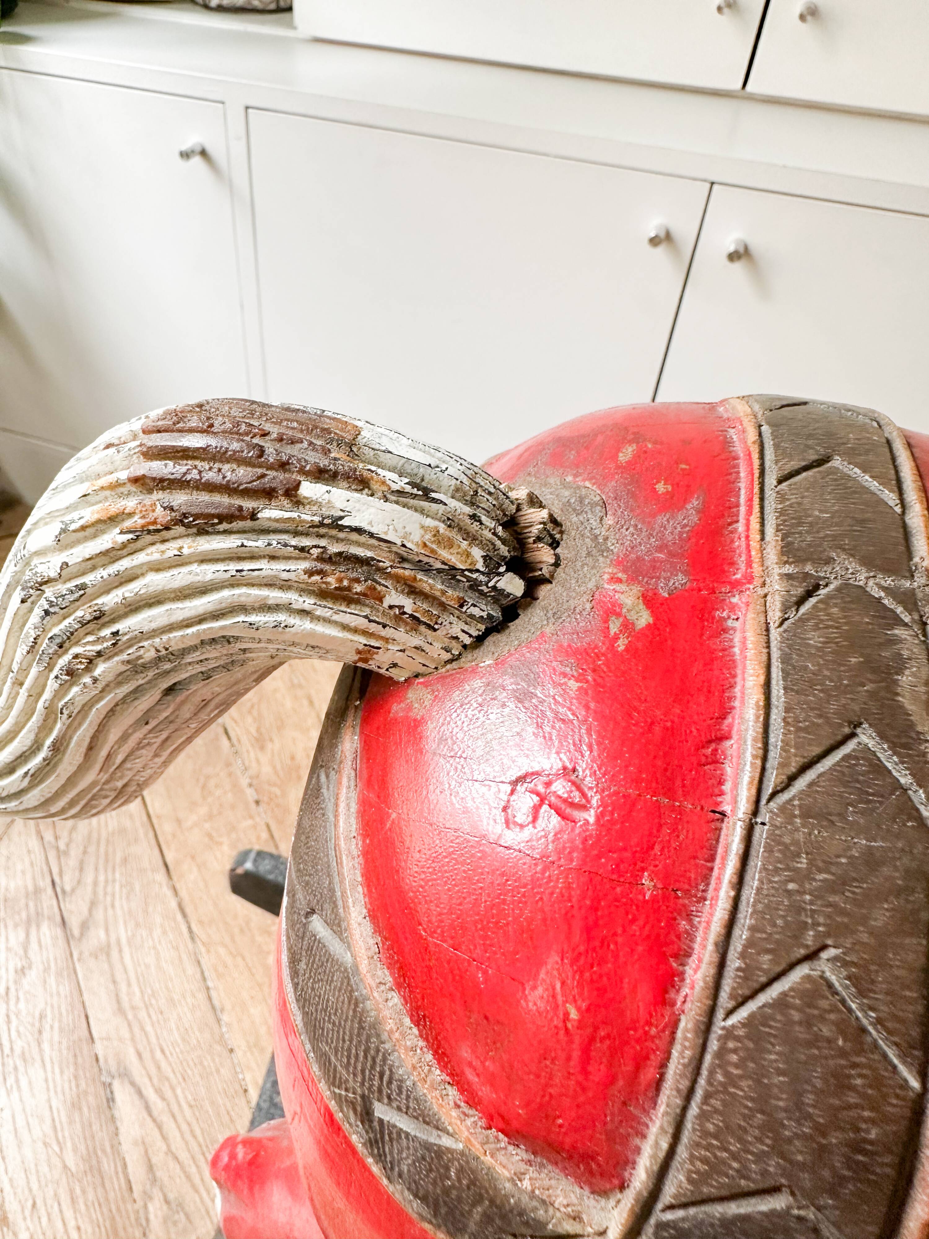Large decorative rocking horse made of carved and hand-painted wood.
