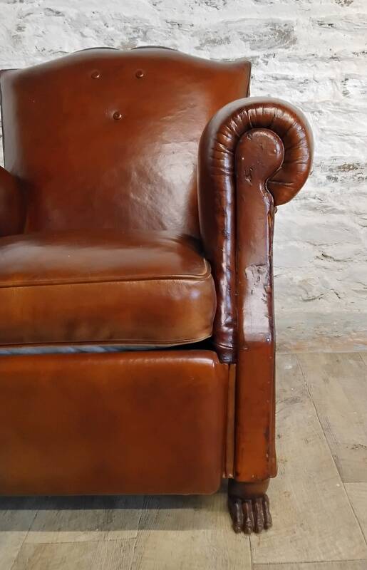 Club chair with moustache back and lion feet.
