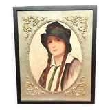 Old portrait of a young woman with braids and a hat, circa 1930