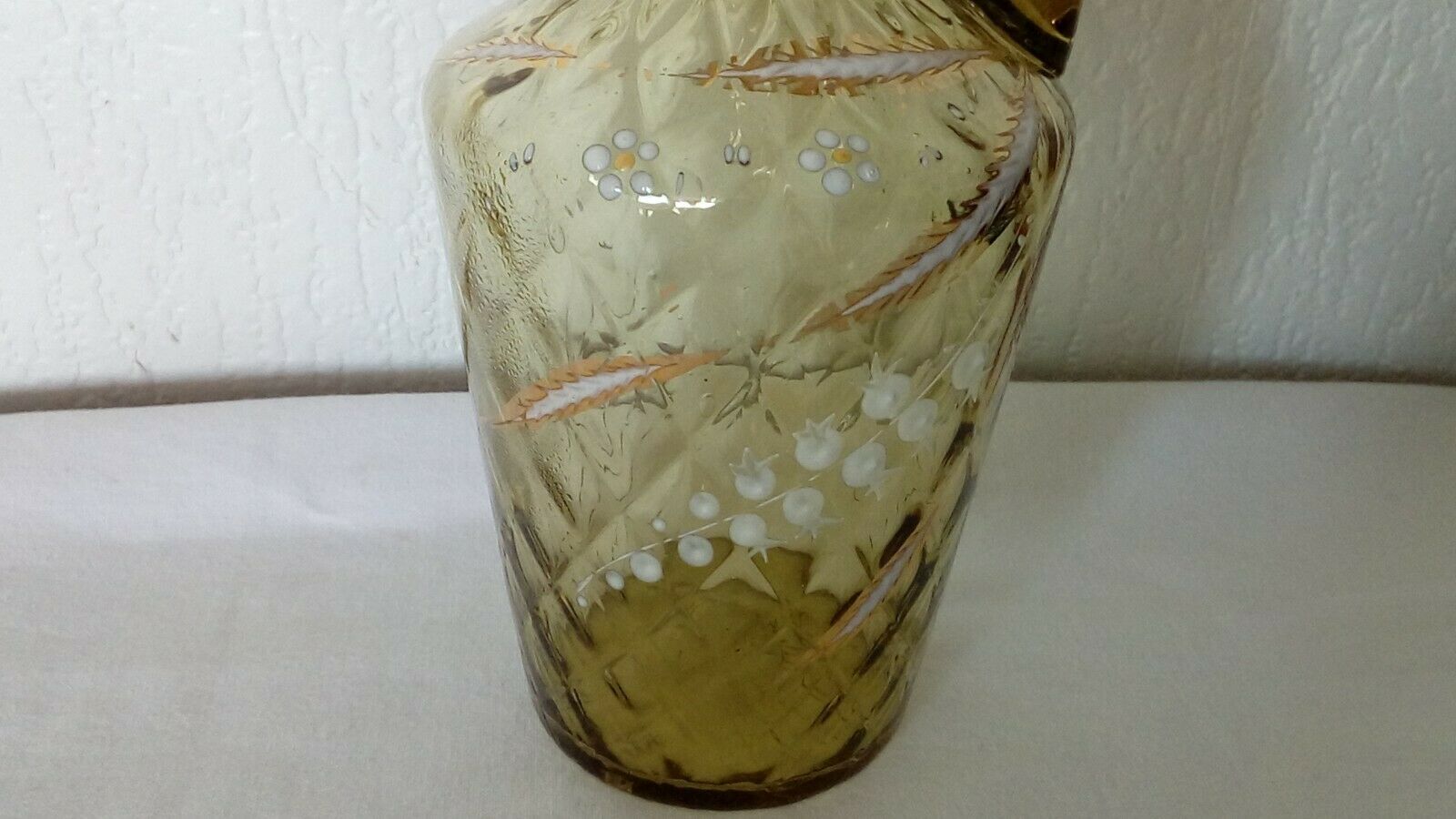Glass carafe with enamelled lily of the valley decoration.