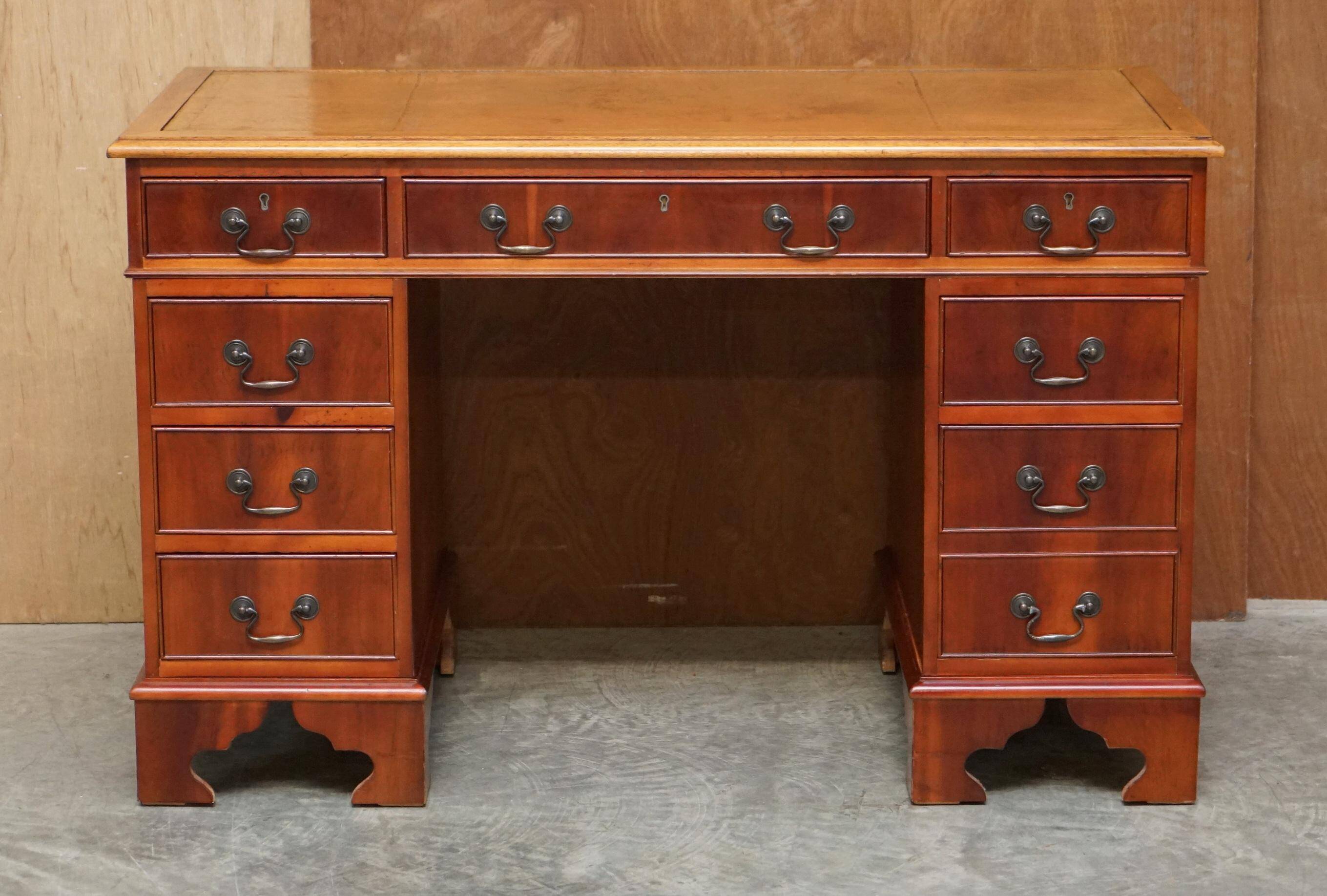 Vintage walnut desk with a leather top and two drawers.