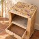 Small Art Deco bedside table in light wood with a terrazzo effect top.