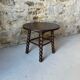 Round wooden coffee table with turned legs.