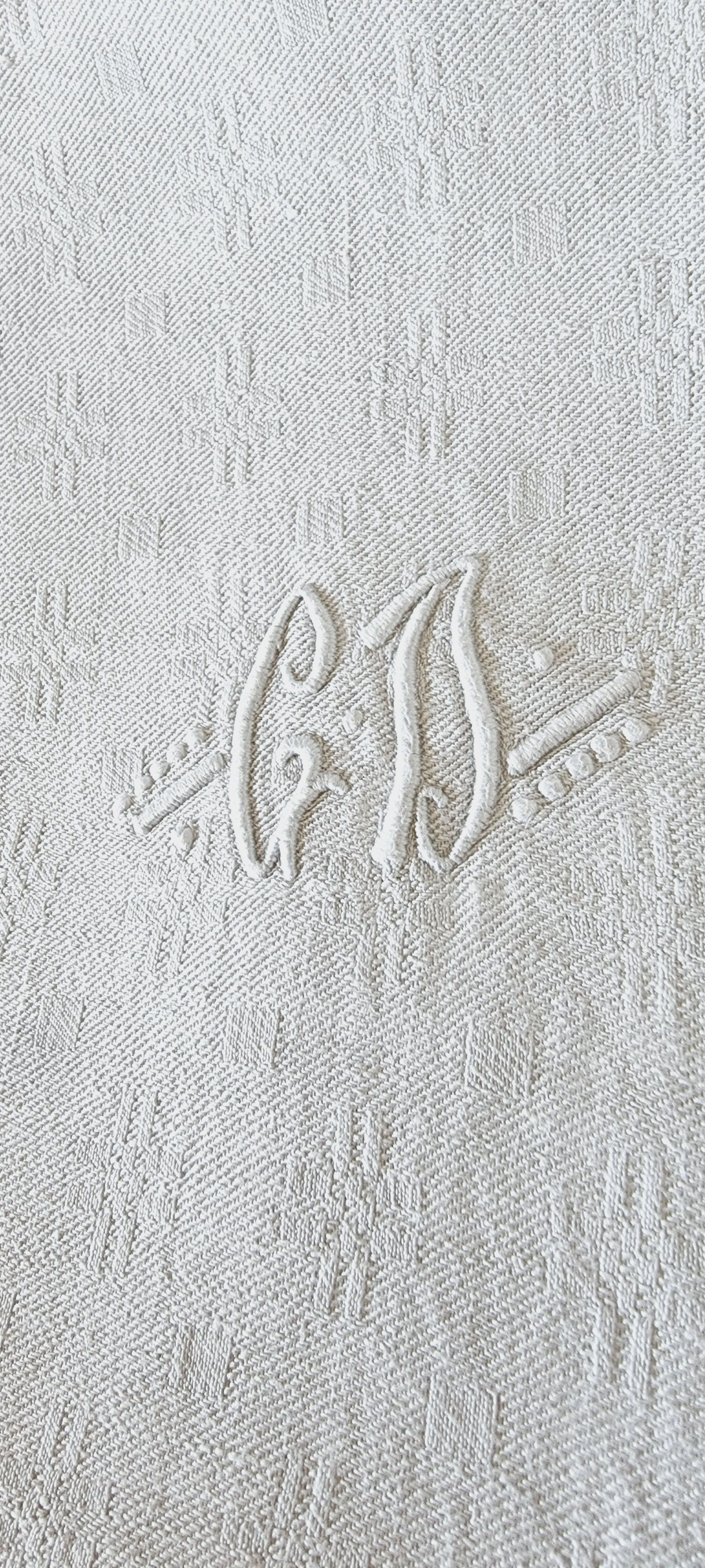 12 antique French linen towels with damask embroidery with "GB" anagrams.