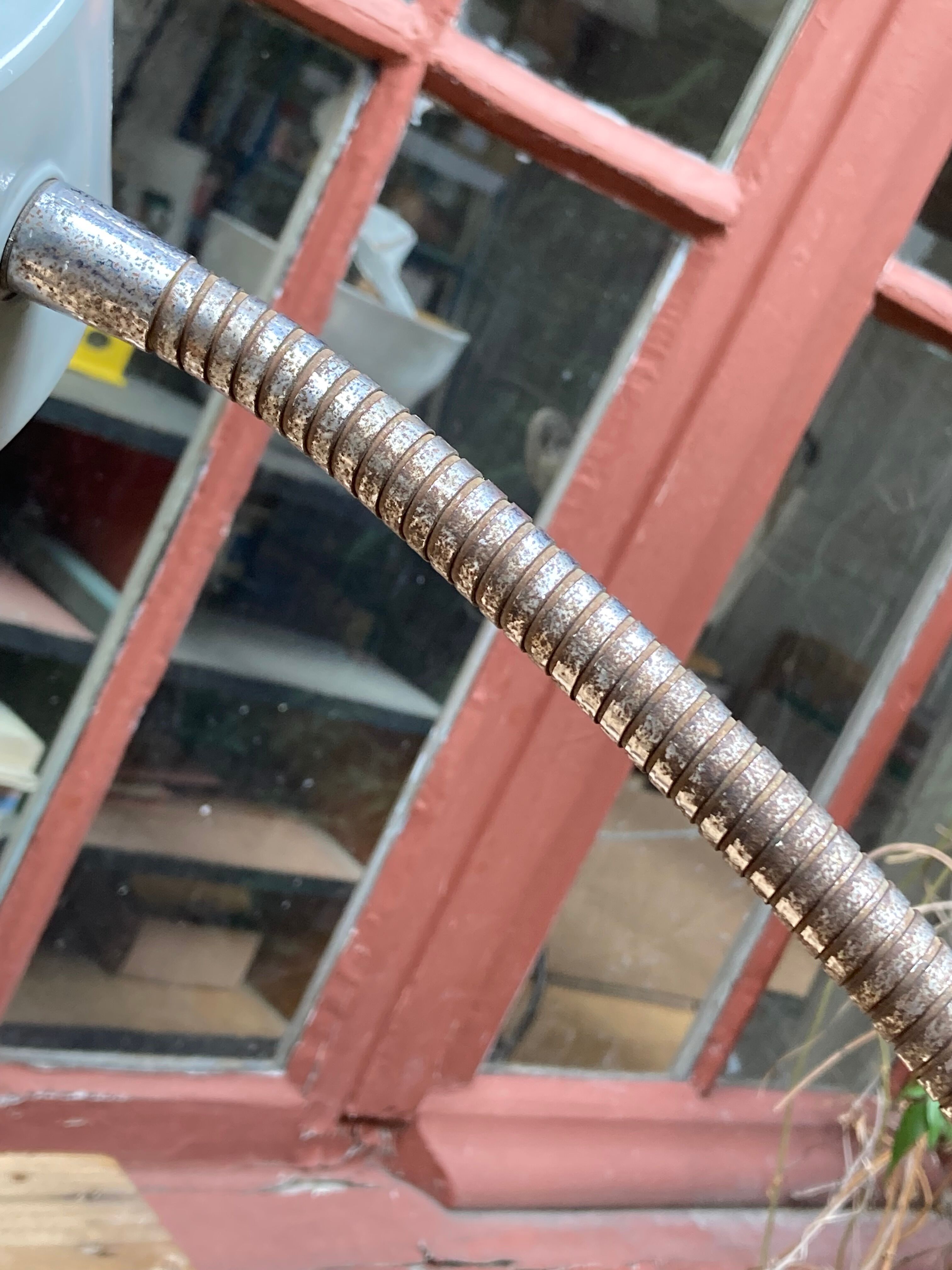 Workshop lamp on ringed metal hose