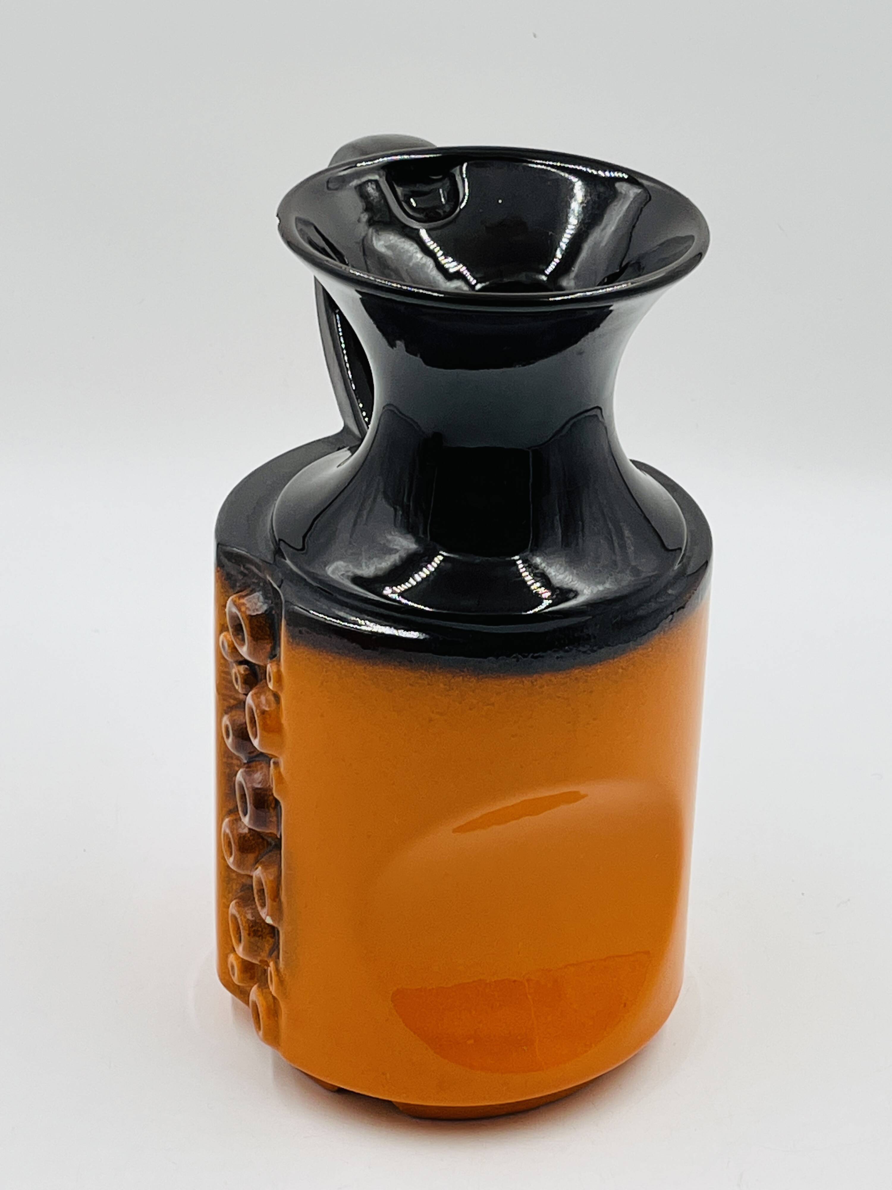Modernist vase design, orange ceramic with relief cabochons from the 1970s.