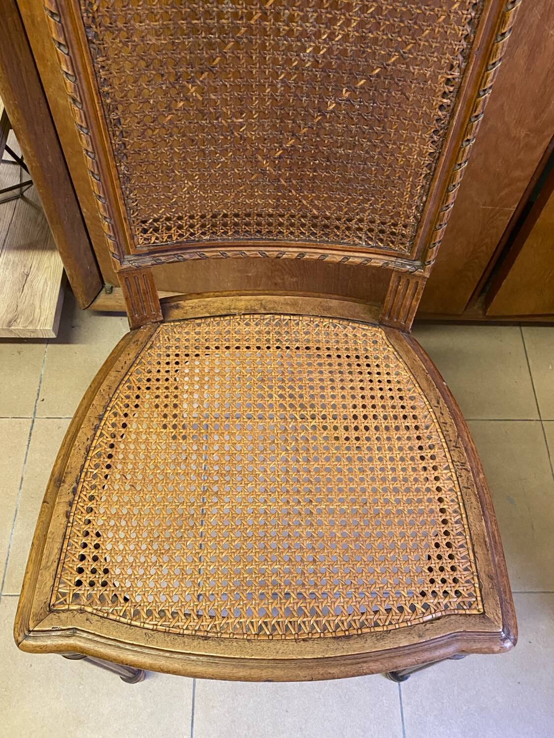 Chair with caned seat and back made of wood