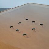 Rare coffee table 110 x 110 x height 35 cm with 8 flange wooden / cork caps in the glass top.