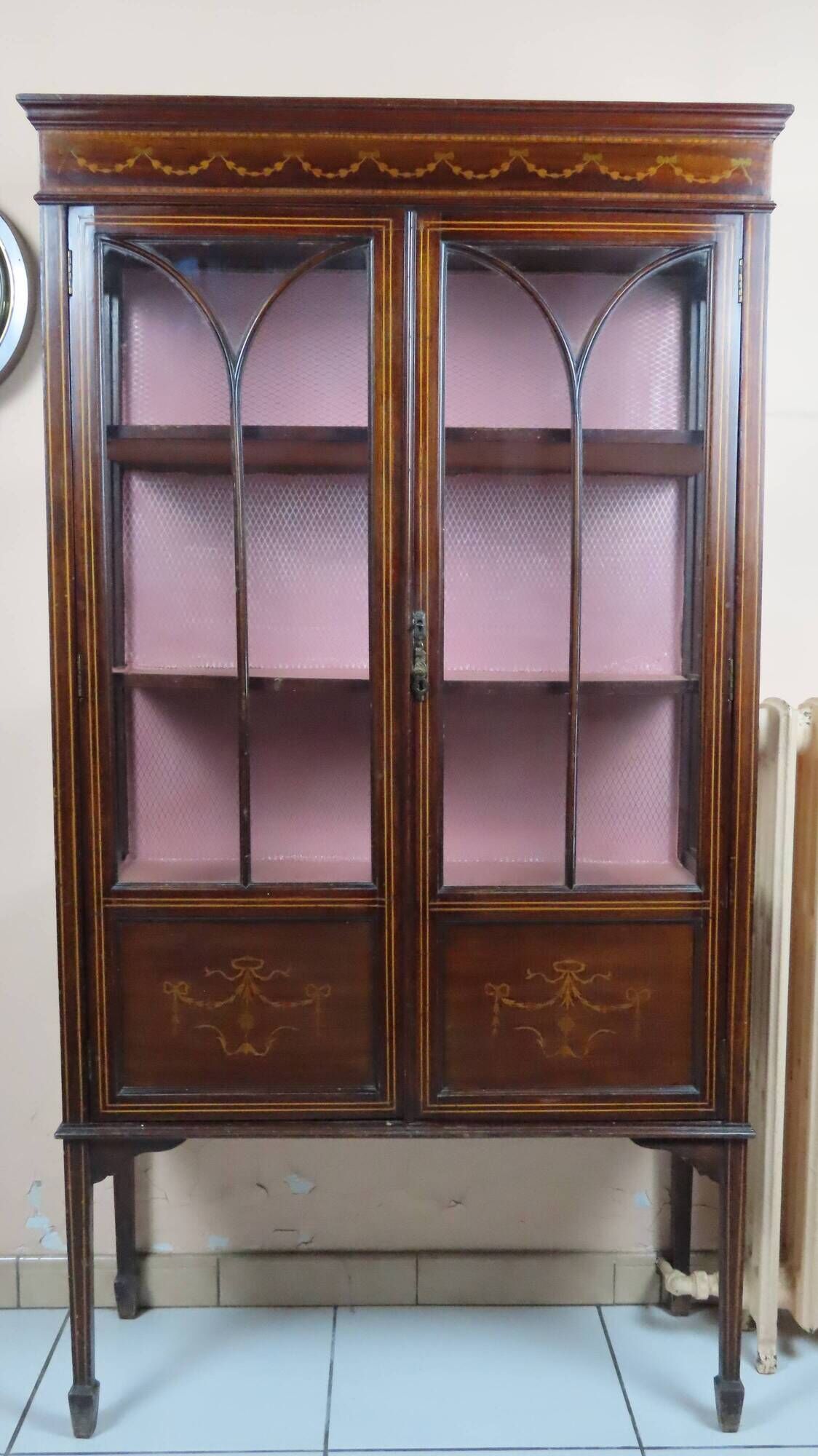 Antique English display cabinet. Marquetry with floral patterns and ribbons.